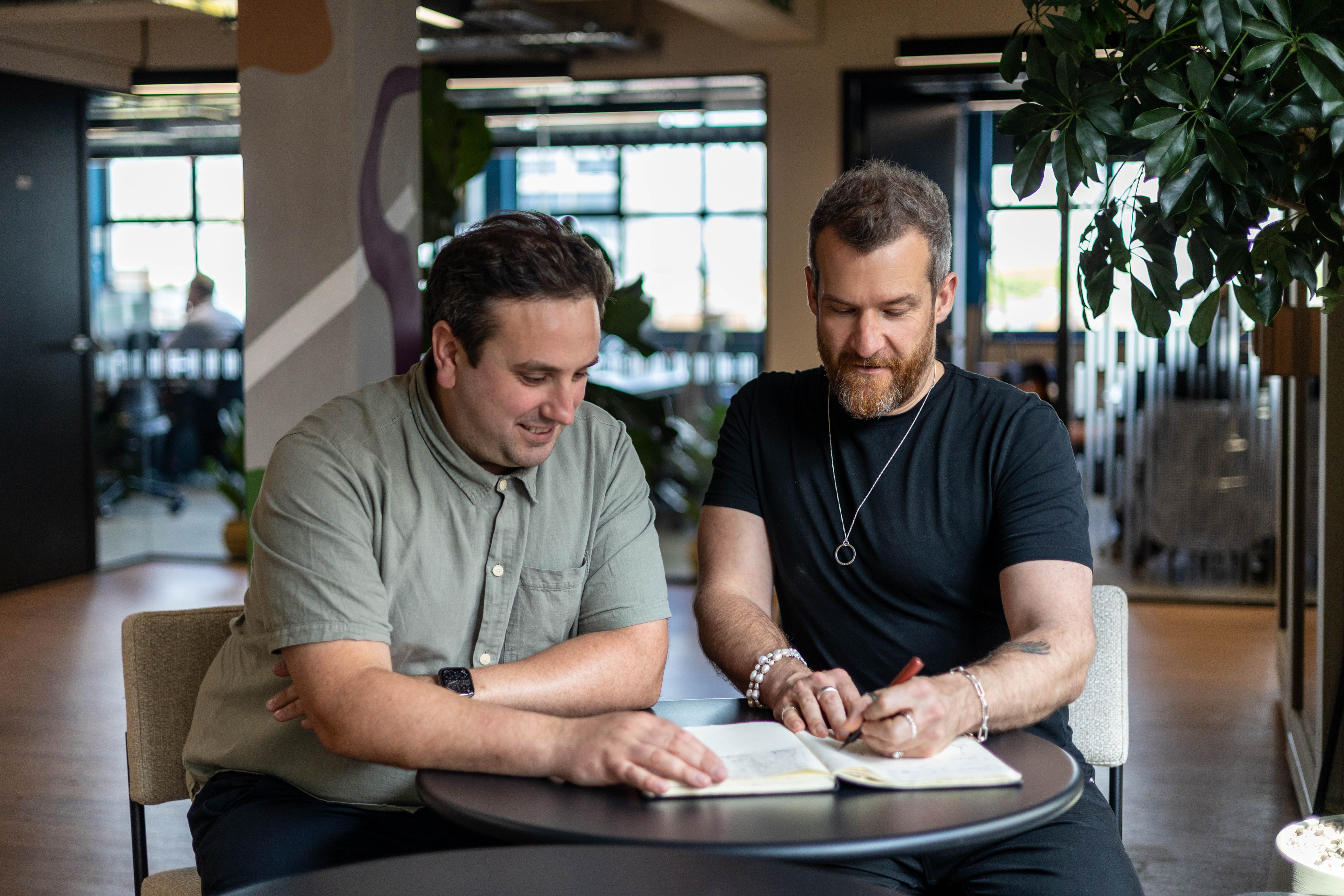 Two members of the GOA team reviewing Google Ads plans together